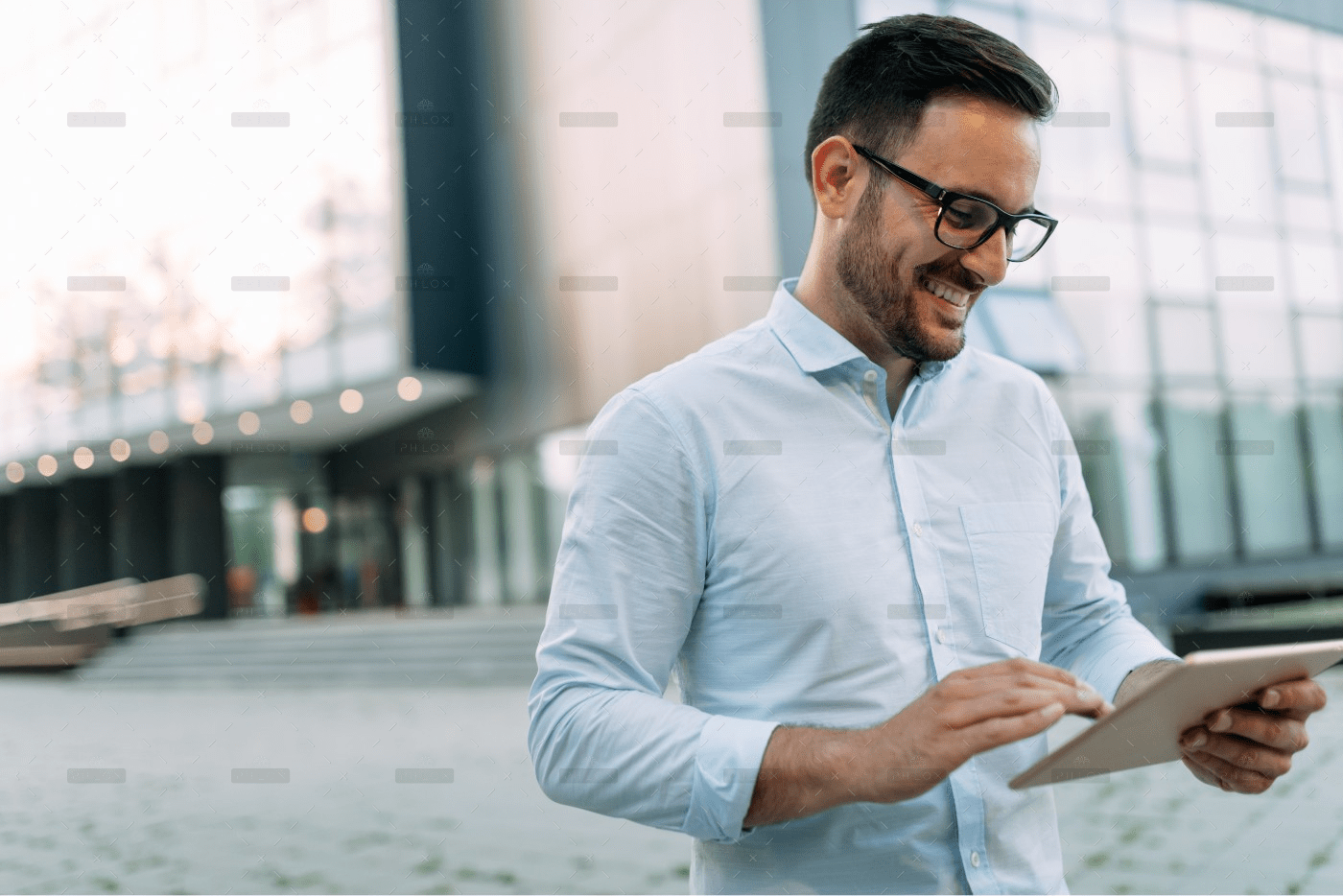 demo-attachment-59-portrait-of-businessman-in-glasses-holding-tablet-AWVHCJU